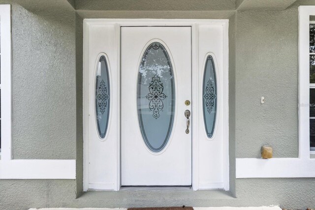 17 Eugenia Ct N, Homosassa, FL 34446 - doorway to property featuring stucco siding