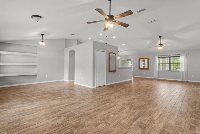 17 Eugenia Ct N, Homosassa, FL 34446 - unfurnished living room with wood finished floors, a ceiling fan, lofted ceiling, and built in features