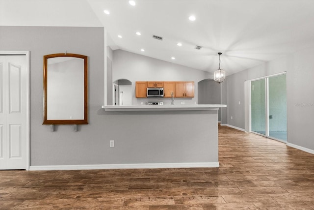17 Eugenia Ct N, Homosassa, FL 34446 - kitchen featuring light countertops, stainless steel microwave, recessed lighting, wood finished floors, and lofted ceiling