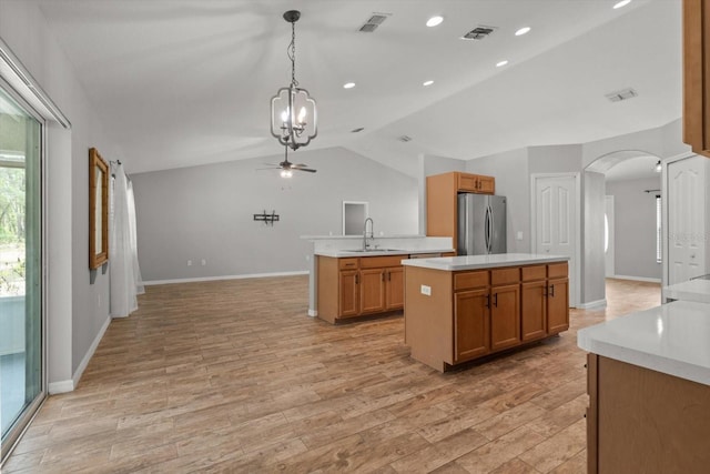 17 Eugenia Ct N, Homosassa, FL 34446 - kitchen featuring light countertops, freestanding refrigerator, visible vents, arched walkways, and ceiling fan with notable chandelier