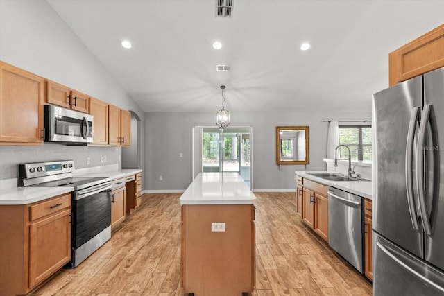 17 Eugenia Ct N, Homosassa, FL 34446 - kitchen with visible vents, a center island, a sink, light wood-type flooring, and stainless steel appliances