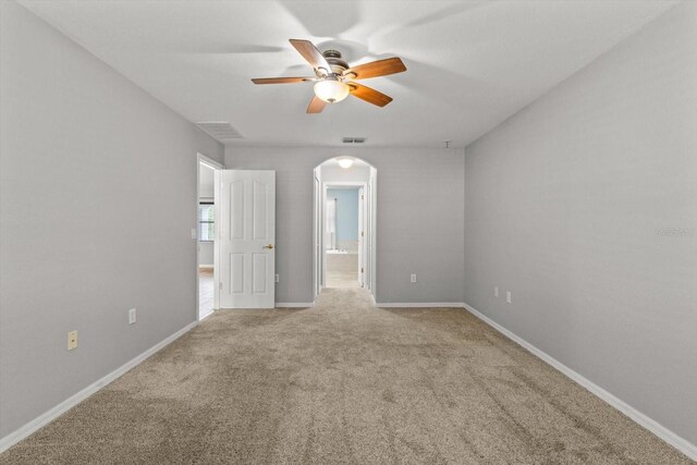 17 Eugenia Ct N, Homosassa, FL 34446 - spare room featuring visible vents, baseboards, arched walkways, a ceiling fan, and carpet floors