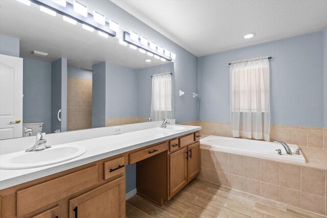 17 Eugenia Ct N, Homosassa, FL 34446 - bathroom with a bath, wood finished floors, double vanity, and a sink