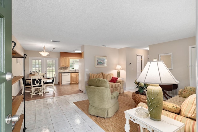 living area with visible vents, a textured ceiling, and light tile patterned flooring