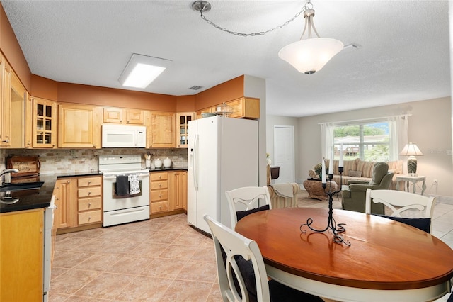 dining area featuring a textured ceiling and light tile patterned floors