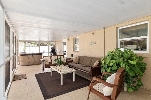 sunroom / solarium with outdoor lounge area, tile patterned flooring, and a hot tub