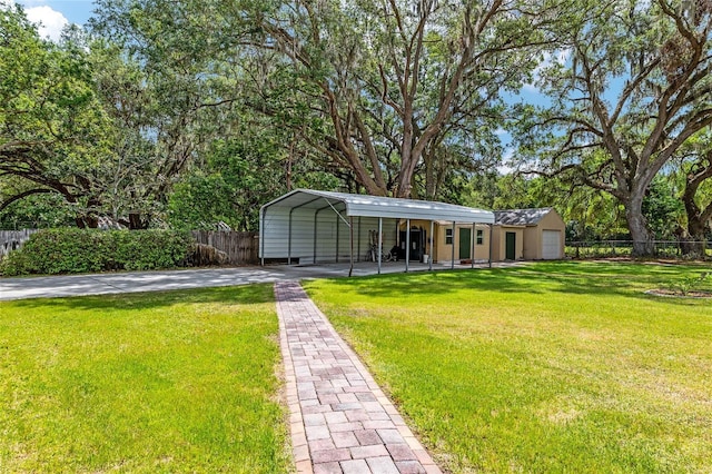 view of front of house featuring a carport, concrete driveway, fence, and a front lawn