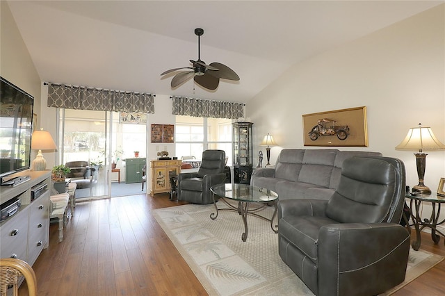 living room with dark wood finished floors, vaulted ceiling, and ceiling fan
