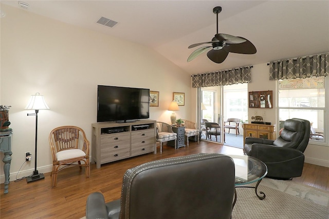 living area with a ceiling fan, visible vents, wood finished floors, lofted ceiling, and baseboards
