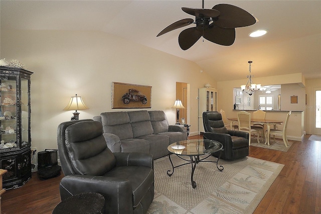 living room featuring ceiling fan with notable chandelier, wood finished floors, and lofted ceiling