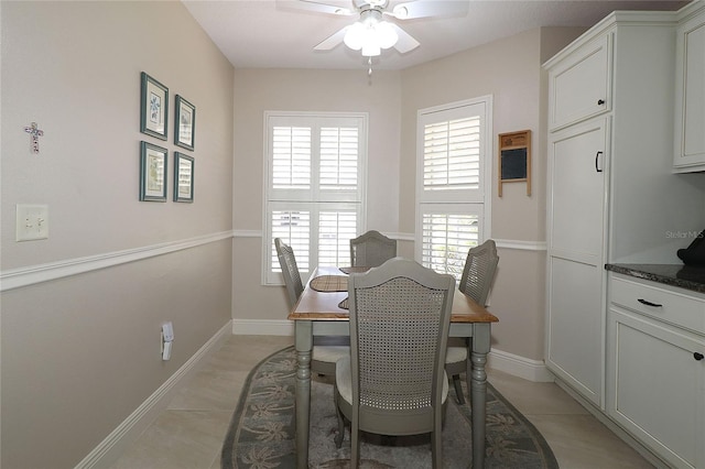 dining area with ceiling fan, light tile patterned flooring, and baseboards