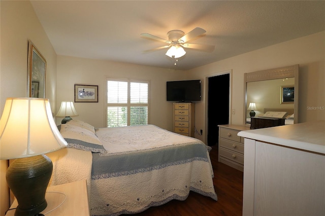 bedroom with dark wood-style floors and a ceiling fan