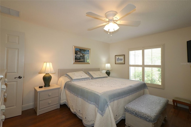 bedroom featuring dark wood-type flooring, ceiling fan, baseboards, and visible vents