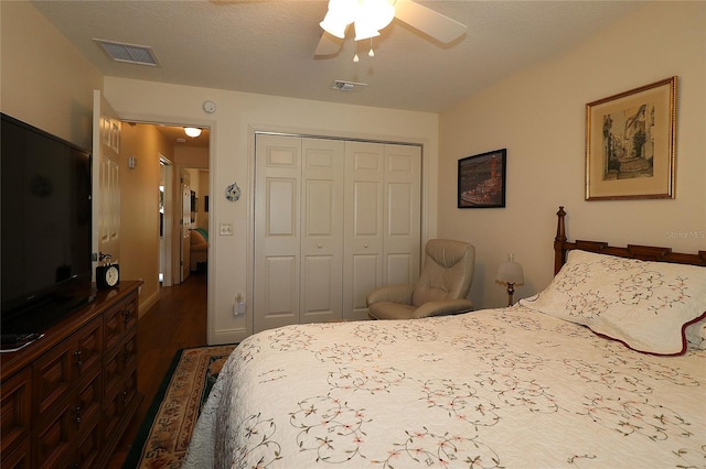 bedroom with visible vents, a ceiling fan, a closet, and wood finished floors