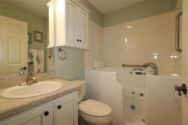 full bath with a tub, vanity, and toilet