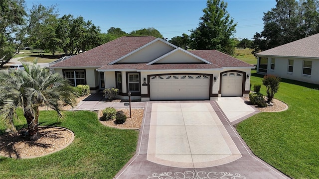 view of front of property with concrete driveway, stucco siding, an attached garage, a front yard, and a shingled roof