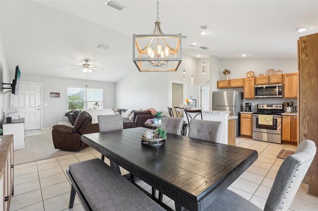 3329 Boyd Cir, Oxford, FL 34484 - dining room featuring light tile patterned floors, a chandelier, lofted ceiling, and ceiling fan