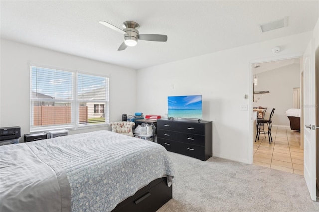 3329 Boyd Cir, Oxford, FL 34484 - bedroom featuring light carpet, ceiling fan, light tile patterned floors, and baseboards
