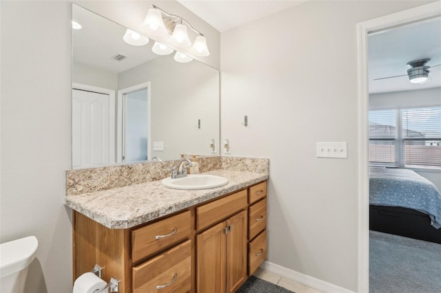 3329 Boyd Cir, Oxford, FL 34484 - half bath with vanity, connected bathroom, toilet, and baseboards