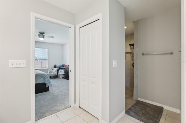 3329 Boyd Cir, Oxford, FL 34484 - ensuite bathroom with a tile shower, tile patterned floors, ceiling fan, and baseboards