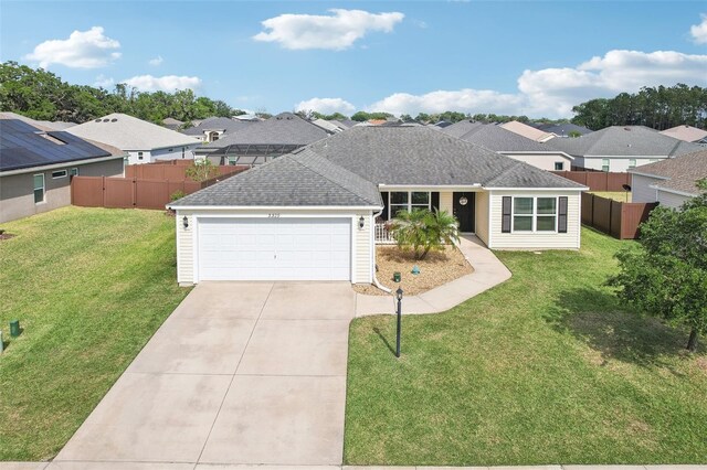 3329 Boyd Cir, Oxford, FL 34484 - view of front of property featuring a garage, concrete driveway, a residential view, and roof with shingles