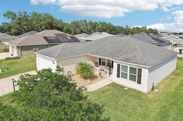 3329 Boyd Cir, Oxford, FL 34484 - view of front of property with a porch, an attached garage, a front lawn, roof with shingles, and concrete driveway