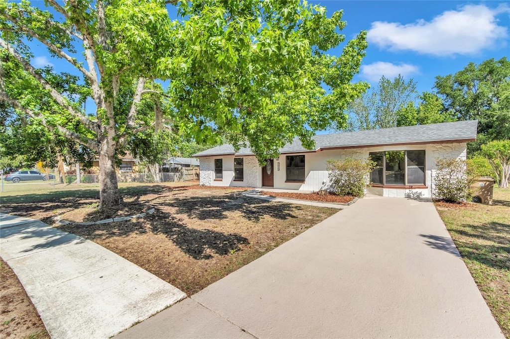 3415 Sail Fish Ave, Fruitland Park, FL 34731 - ranch-style home with driveway and fence