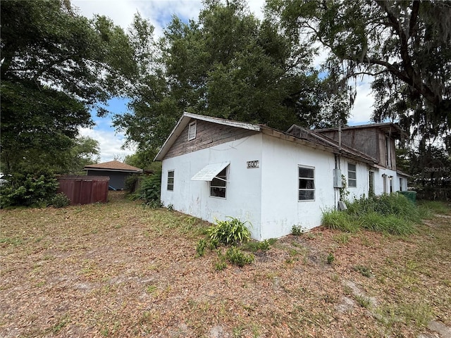 view of side of property featuring stucco siding