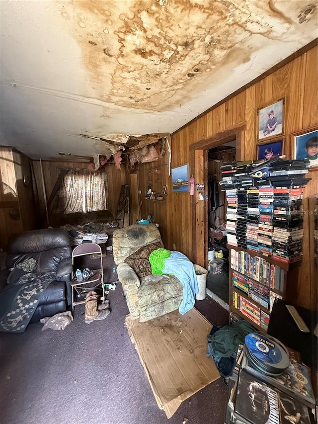 living area with wooden walls and carpet flooring