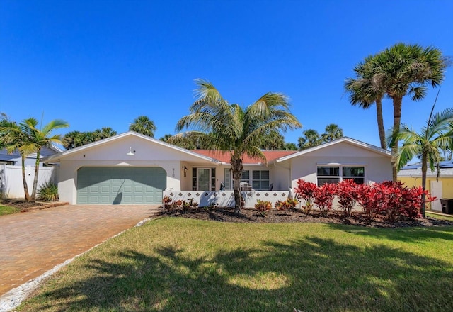 ranch-style home with a garage, decorative driveway, and stucco siding