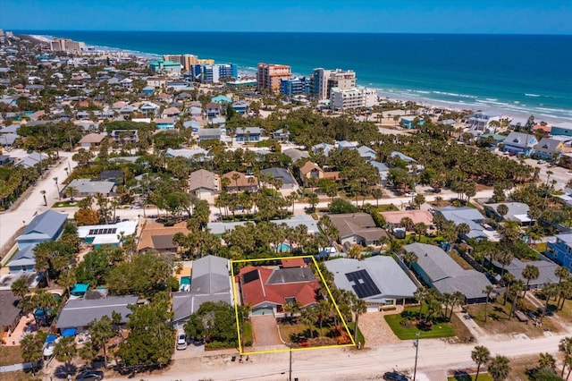 aerial view of residential area featuring a nearby body of water and property parcel outlined