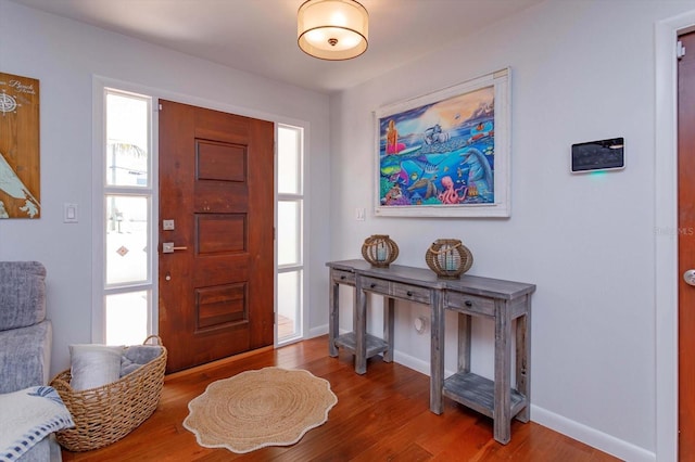 foyer featuring wood finished floors and baseboards