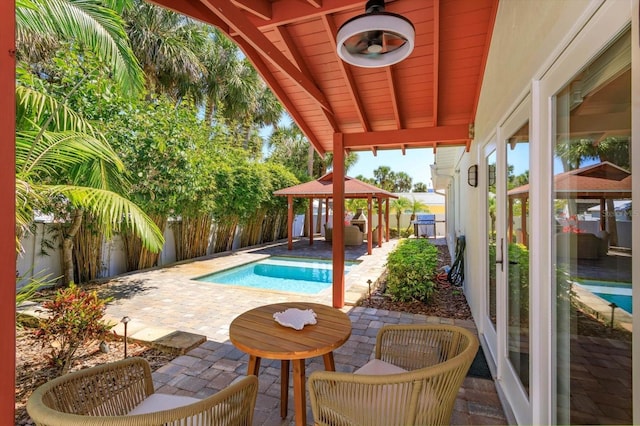 view of swimming pool with a gazebo, a patio area, and a fenced backyard
