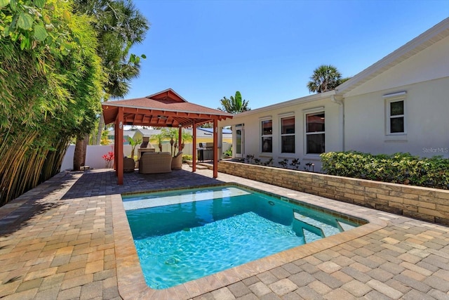 view of swimming pool featuring a gazebo, a patio area, and a fenced backyard