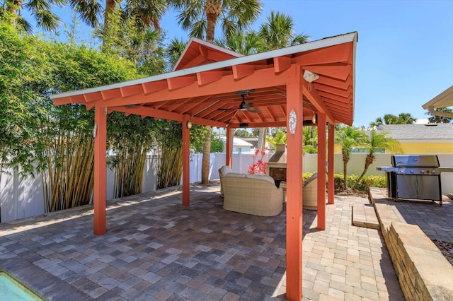 view of patio / terrace featuring a gazebo, a grill, ceiling fan, and a fenced backyard