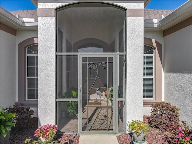 25523 Maurepas Ln, Leesburg, FL 34748 - entrance to property with roof with shingles and stucco siding