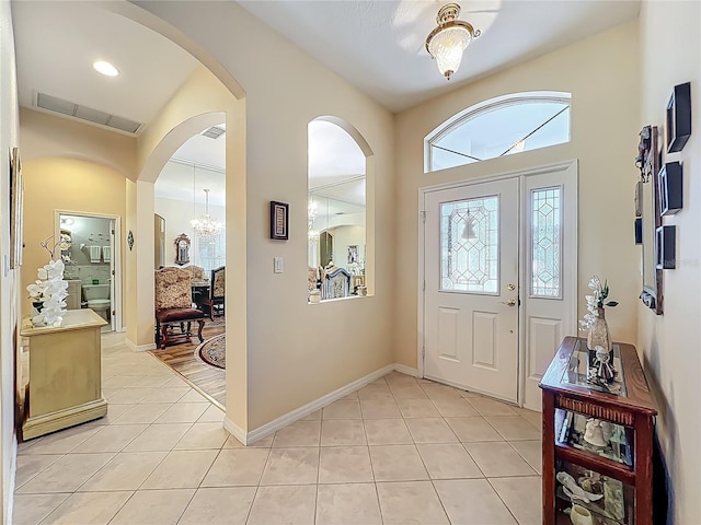 25523 Maurepas Ln, Leesburg, FL 34748 - entrance foyer with arched walkways, light tile patterned floors, and visible vents