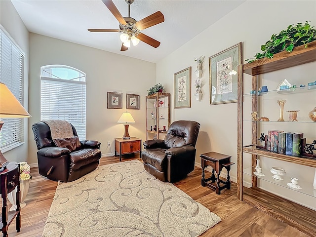 25523 Maurepas Ln, Leesburg, FL 34748 - living area featuring baseboards, light wood-type flooring, and a ceiling fan