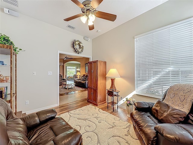25523 Maurepas Ln, Leesburg, FL 34748 - living room featuring visible vents, ceiling fan, light wood-style floors, and baseboards
