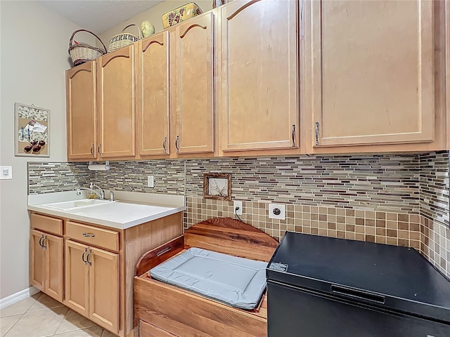 25523 Maurepas Ln, Leesburg, FL 34748 - kitchen featuring light tile patterned floors, tasteful backsplash, light countertops, a sink, and light brown cabinets