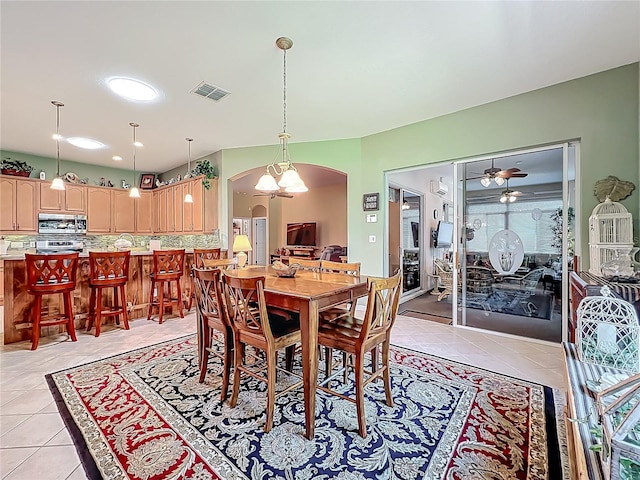 25523 Maurepas Ln, Leesburg, FL 34748 - dining area with arched walkways, light tile patterned floors, ceiling fan, and visible vents