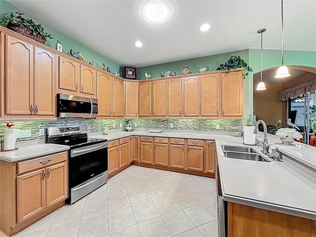 25523 Maurepas Ln, Leesburg, FL 34748 - kitchen featuring a sink, light countertops, appliances with stainless steel finishes, and pendant lighting