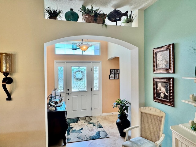 1985 Abordale Ln, The Villages, FL 32162 - tiled entryway featuring arched walkways, a high ceiling, and a healthy amount of sunlight