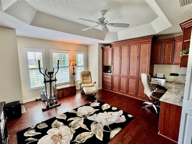 1985 Abordale Ln, The Villages, FL 32162 - home office featuring dark wood-style flooring, a textured ceiling, a ceiling fan, visible vents, and a tray ceiling