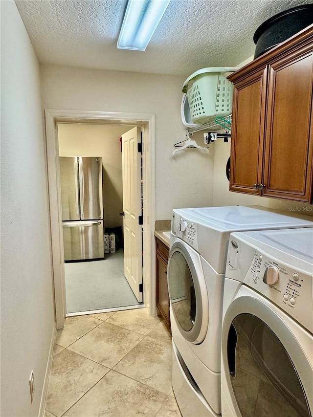 1985 Abordale Ln, The Villages, FL 32162 - laundry area featuring washer and dryer, a textured ceiling, and cabinet space