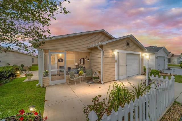 312 Emmalee Pl, The Villages, FL 32162 - view of front facade with a sunroom, a garage, fence, concrete driveway, and a front lawn