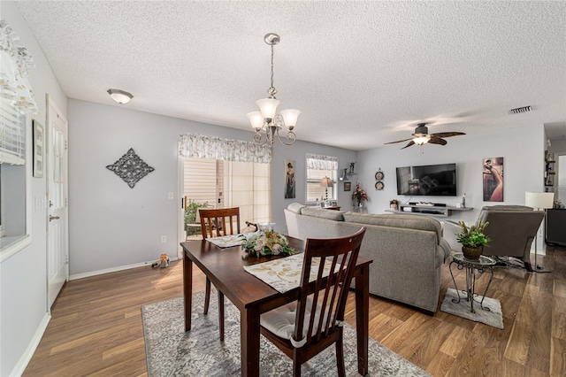 312 Emmalee Pl, The Villages, FL 32162 - dining room with a textured ceiling, wood finished floors, and ceiling fan with notable chandelier