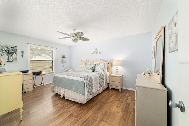 312 Emmalee Pl, The Villages, FL 32162 - bedroom with ceiling fan, baseboards, light wood-style floors, and a textured ceiling