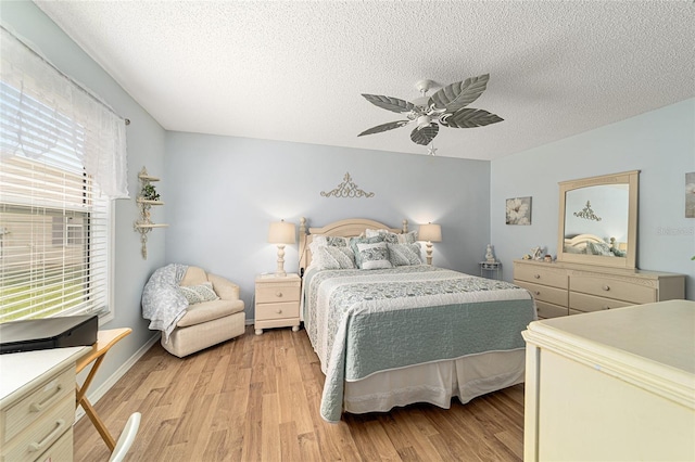 312 Emmalee Pl, The Villages, FL 32162 - bedroom with light wood-style flooring, a textured ceiling, and ceiling fan