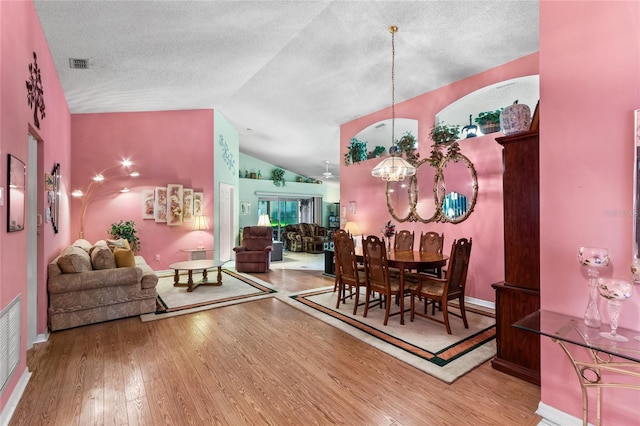 3603 Westerham Dr, Clermont, FL 34711 - dining area with a textured ceiling, visible vents, wood finished floors, lofted ceiling, and baseboards